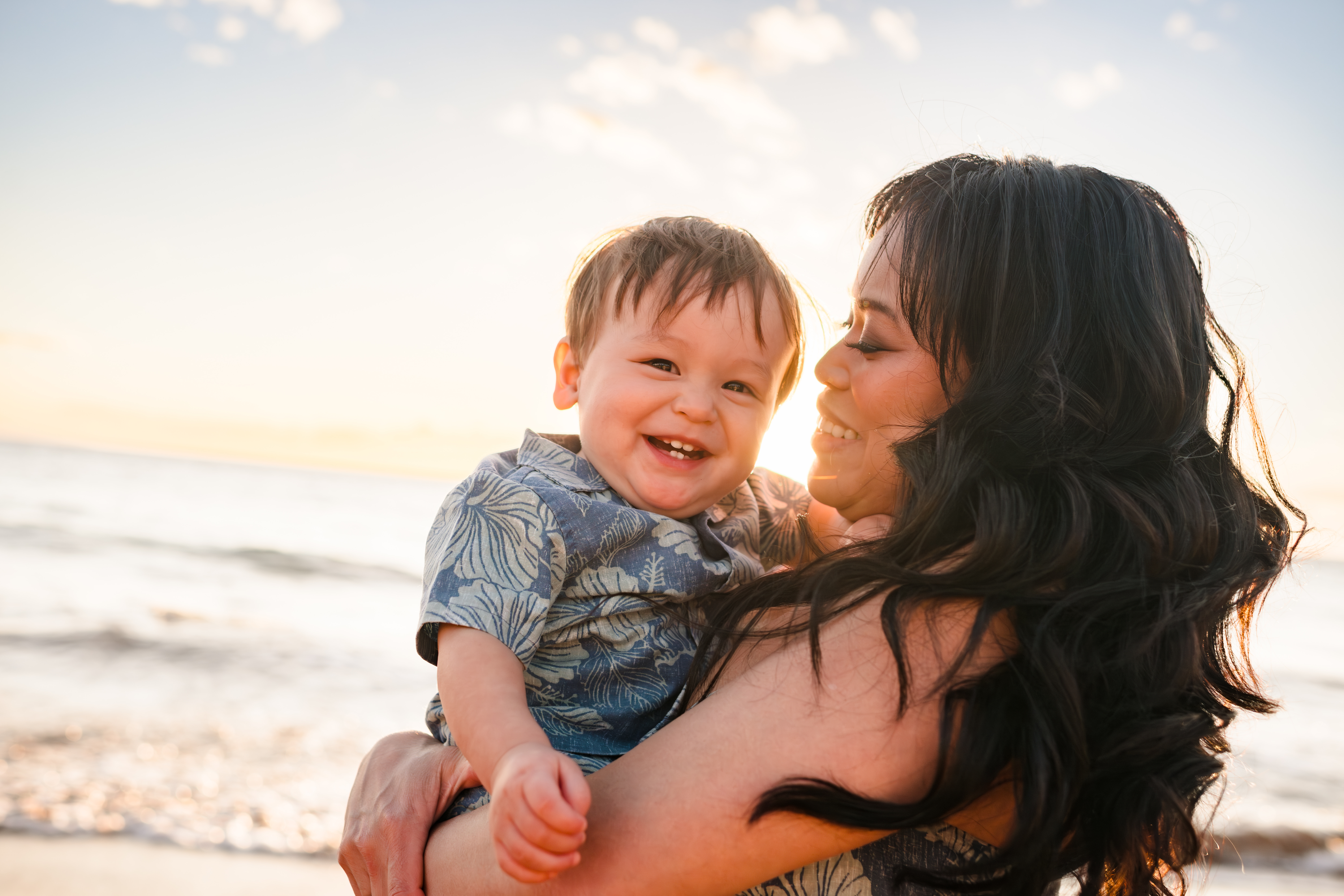 Jes holding Apollo on the beach in Maui